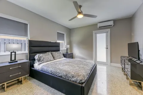 a bedroom with a bed and a flat screen tv