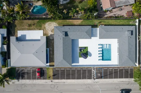 an aerial view of a house with a swimming pool