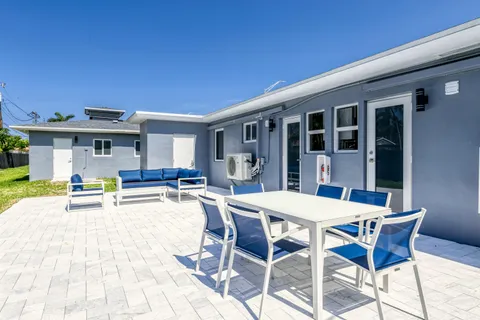 a view of a dining table and chairs in the patio