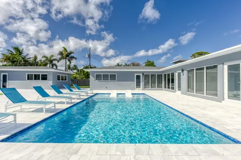 a view of house with swimming pool and porch with furniture