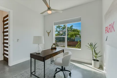 a workspace with furniture and a potted plant