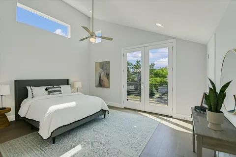 a bedroom with a large bed and a potted plant