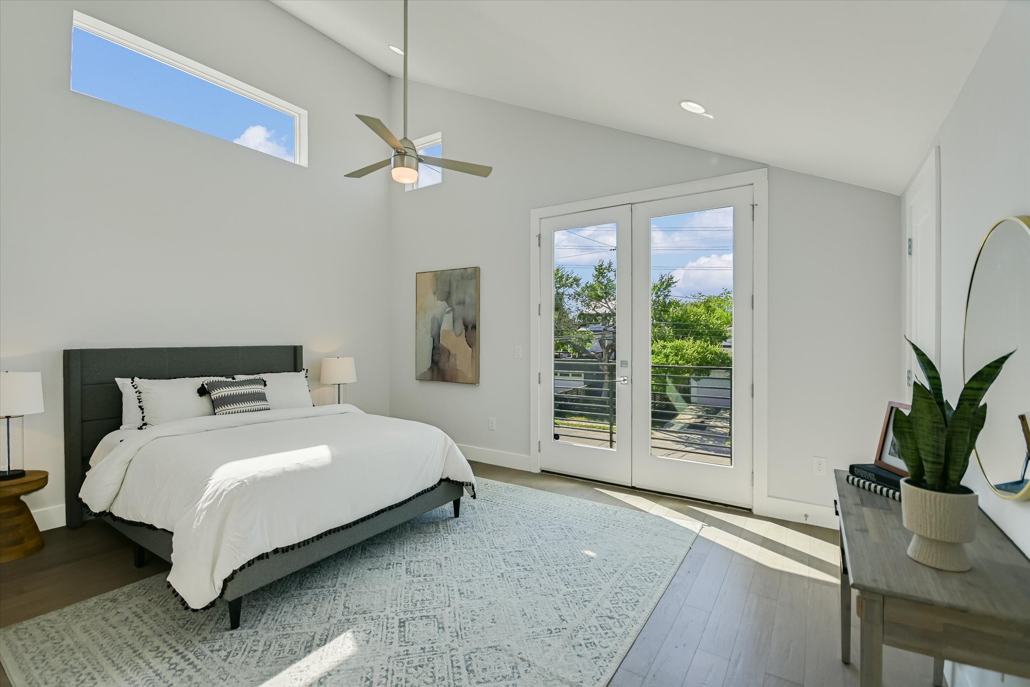 1131 Mason Avenue, Unit A Austin, TX 78721 - Photo 13 of 24 a bedroom with a large bed and a potted plant