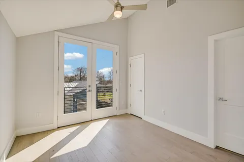 an empty room with windows and closet