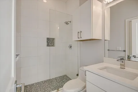 a bathroom with a sink toilet and shower
