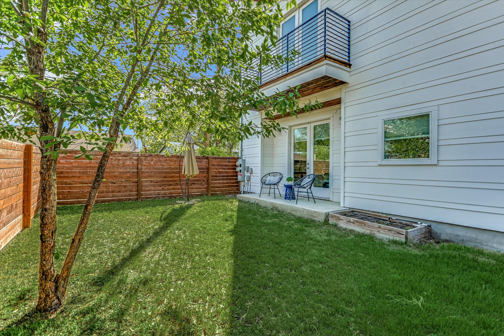 1131 Mason Avenue, Unit A Austin, TX 78721 - Photo 23 of 24 a view of a backyard with plants and a backyard