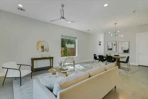 a living room with furniture and a wooden floor