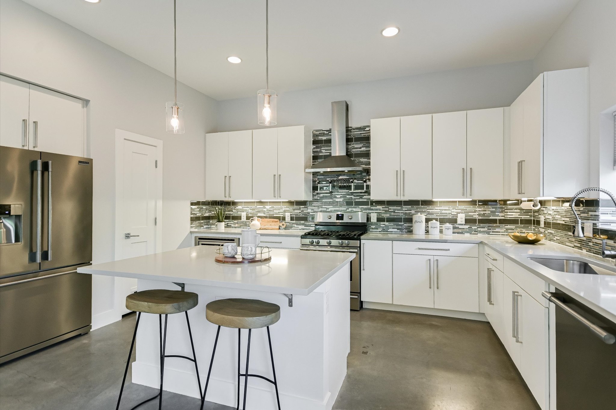 1131 Mason Avenue, Unit A Austin, TX 78721 - Photo 9 of 24 a kitchen with stainless steel appliances granite countertop a stove a sink and white cabinets