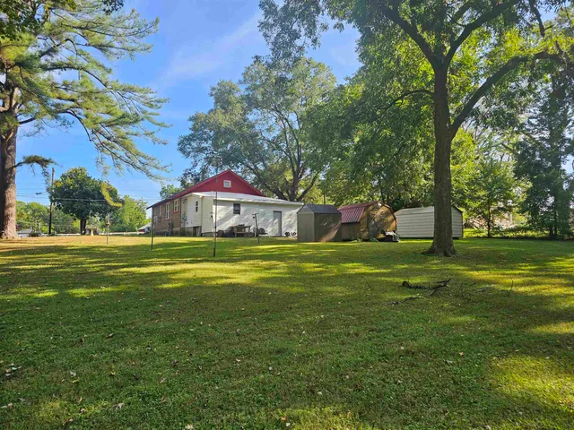 a front view of a house with a yard table and chairs
