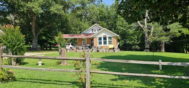 a front view of a house with a yard table and chairs