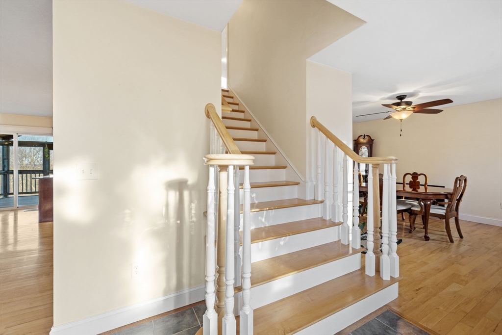 358 Reed Road Mason, NH 03048 - Photo 6 of 42 a view of a hallway with wooden floor and dining room