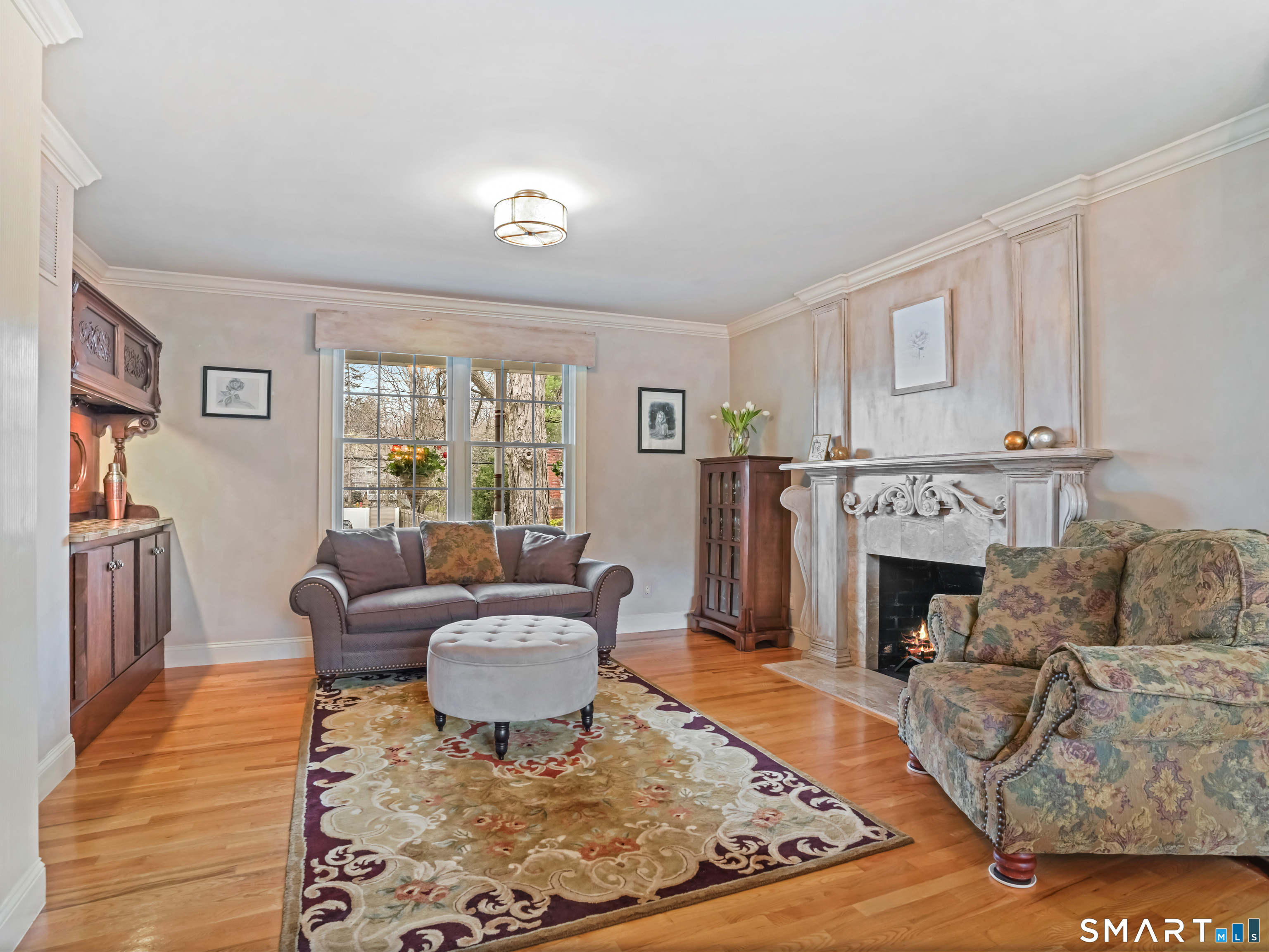 82 Ramapoo Road Ridgefield, CT 06877 - Photo 17 of 40 a living room with furniture and a fireplace