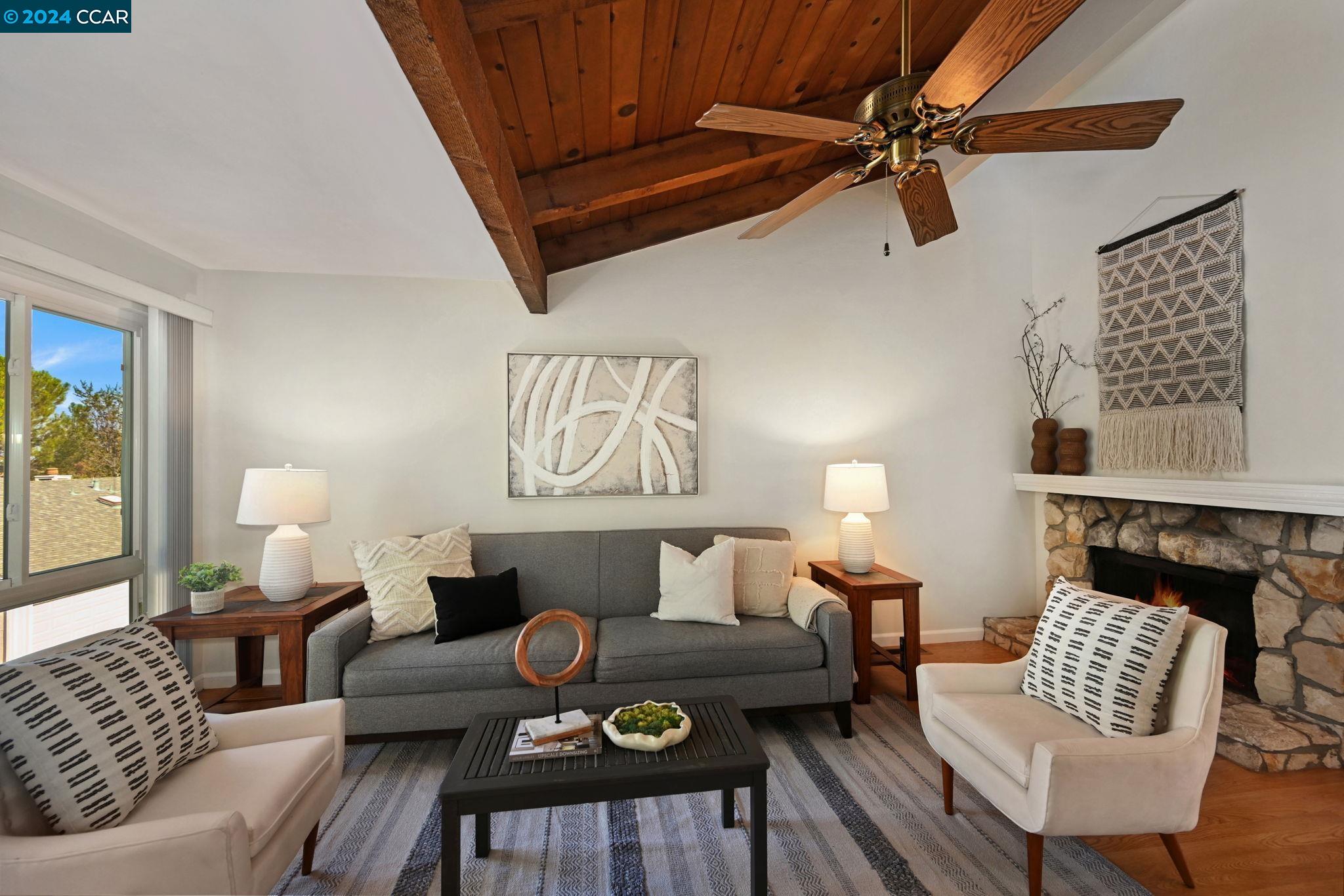 a living room with furniture and a fireplace