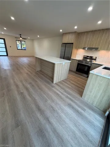a view of kitchen with cabinets and wooden floor