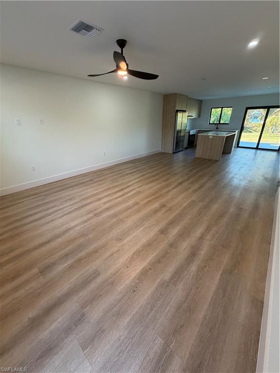3619 Poplar Way, Unit B Naples, FL 34112 - Photo 16 of 17 an empty room with wooden floor and windows