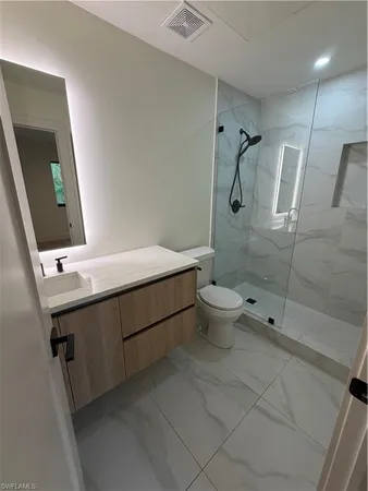 a bathroom with a sink toilet and shower