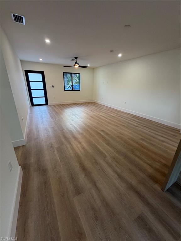 3619 Poplar Way, Unit B Naples, FL 34112 - Photo 6 of 17 wooden floor in an empty room with a window
