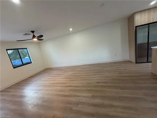 wooden floor in an empty room with a window
