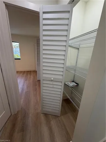 a view of a hallway with wooden floor