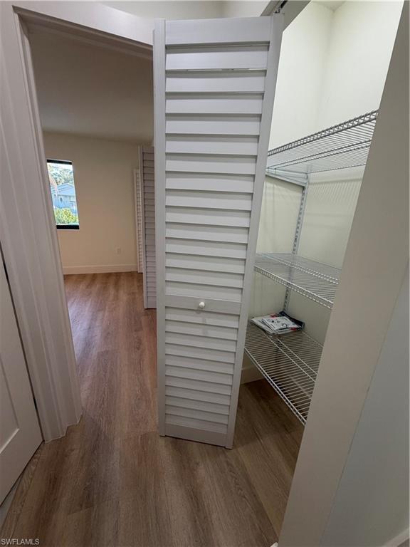 3619 Poplar Way, Unit B Naples, FL 34112 - Photo 9 of 17 a view of a hallway with wooden floor