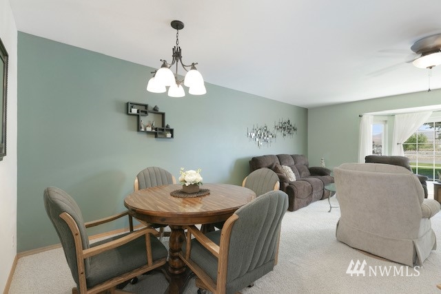 8970 Postma Road Moxee, WA 98936 - Photo 14 of 31 a view of a dining room with furniture wooden floor and chandelier