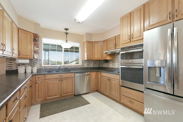 8970 Postma Road Moxee, WA 98936 - Photo 17 of 31 a kitchen with stainless steel appliances granite countertop a refrigerator and a sink