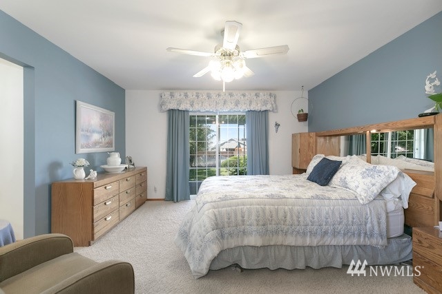 8970 Postma Road Moxee, WA 98936 - Photo 20 of 31 a bedroom with a large bed and a chandelier