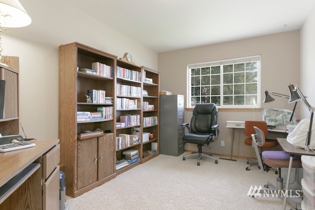 8970 Postma Road Moxee, WA 98936 - Photo 23 of 31 a view of a workspace with furniture and a bookshelf