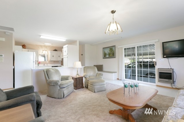 8970 Postma Road Moxee, WA 98936 - Photo 25 of 31 a living room with furniture a fireplace and a flat screen tv