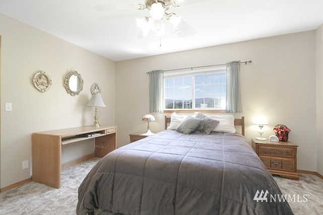 8970 Postma Road Moxee, WA 98936 - Photo 28 of 31 a bedroom with a large bed and a chandelier