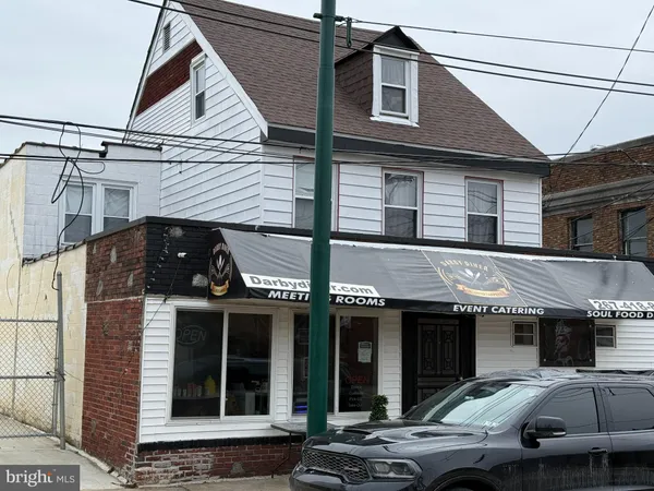 a car parked in front of white building