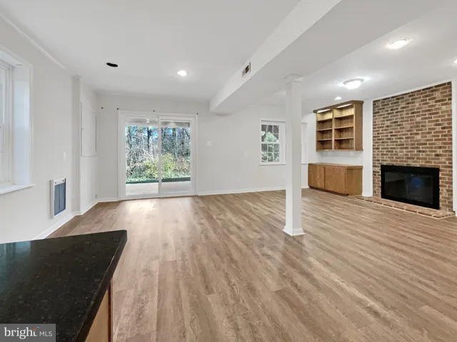 a view of a kitchen with wooden floor and a kitchen
