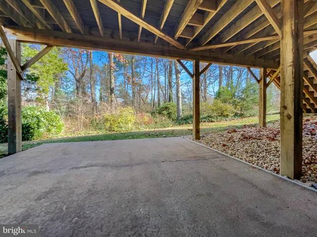 a view of deck with wooden floor and trees