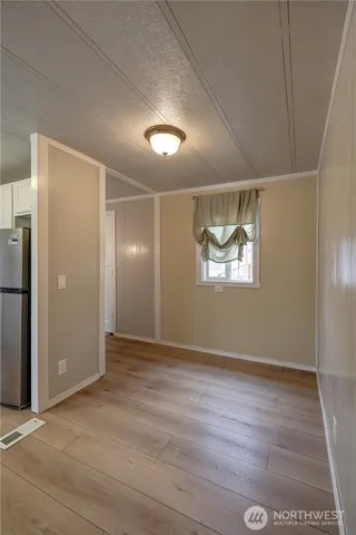 an empty room with windows and closet