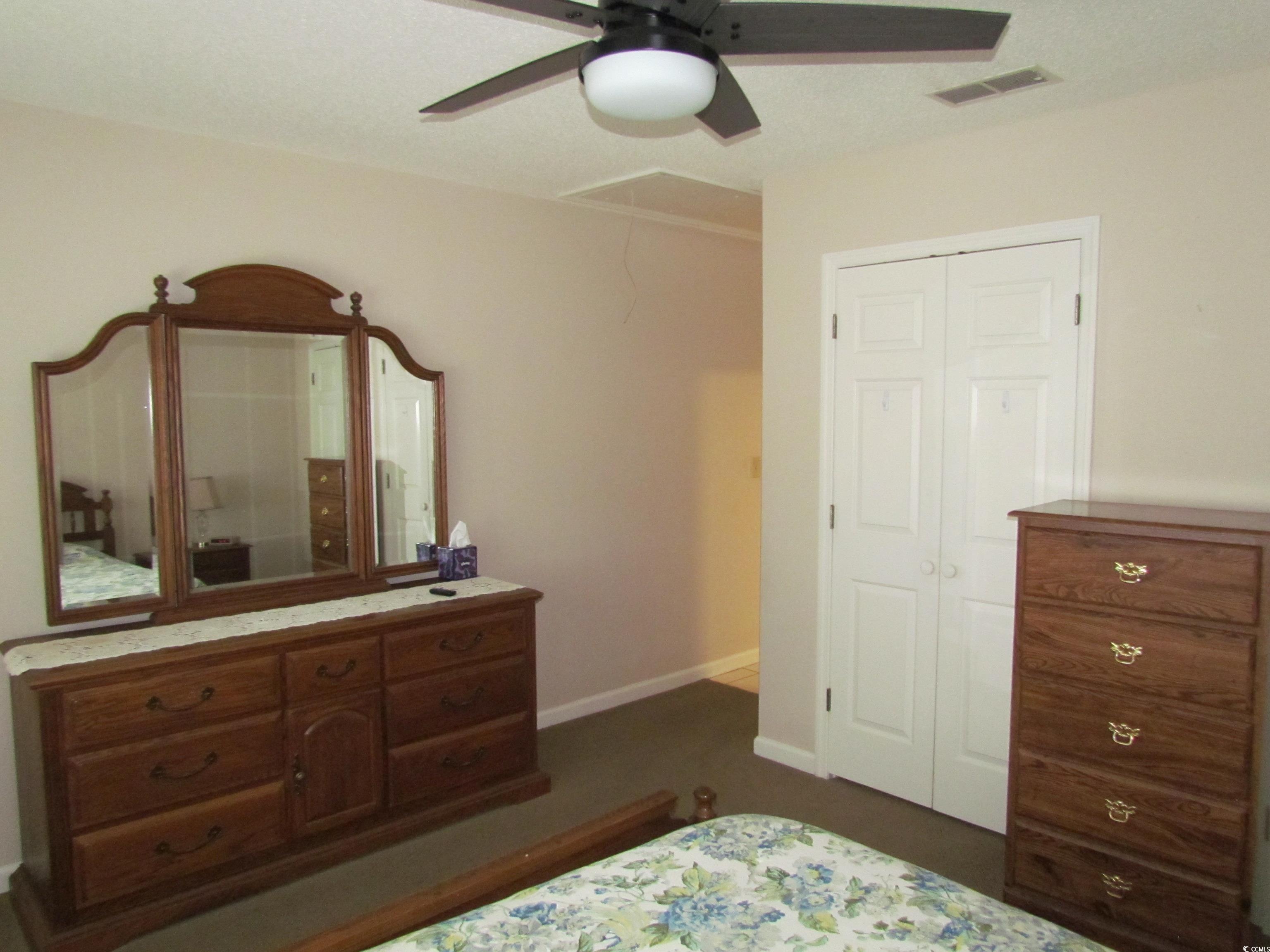 100 Inverness Court Myrtle Beach, SC 29588 - Photo 14 of 22 Bedroom featuring a ceiling fan and a closet