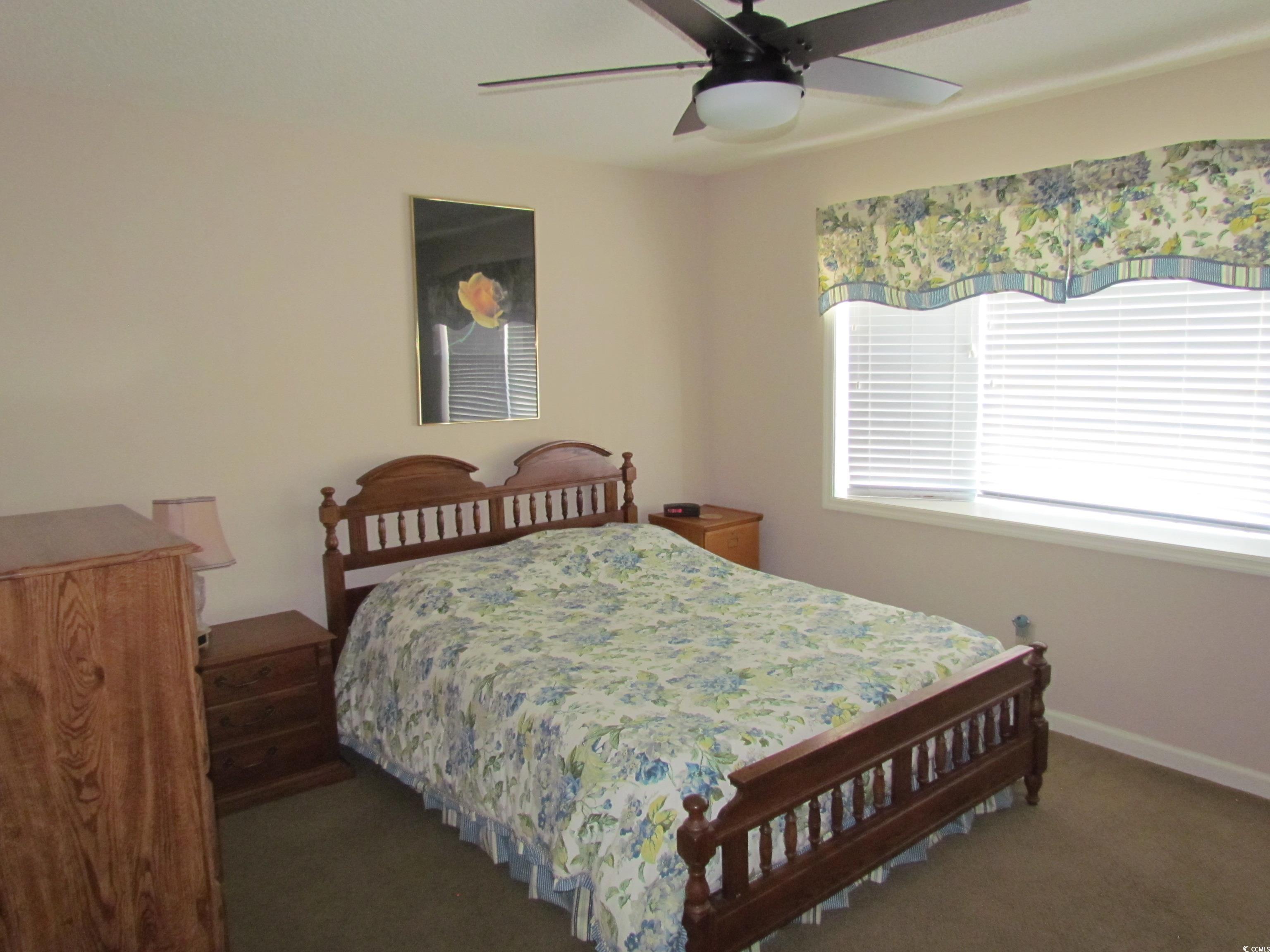 100 Inverness Court Myrtle Beach, SC 29588 - Photo 15 of 22 Bedroom featuring a ceiling fan and dark carpet