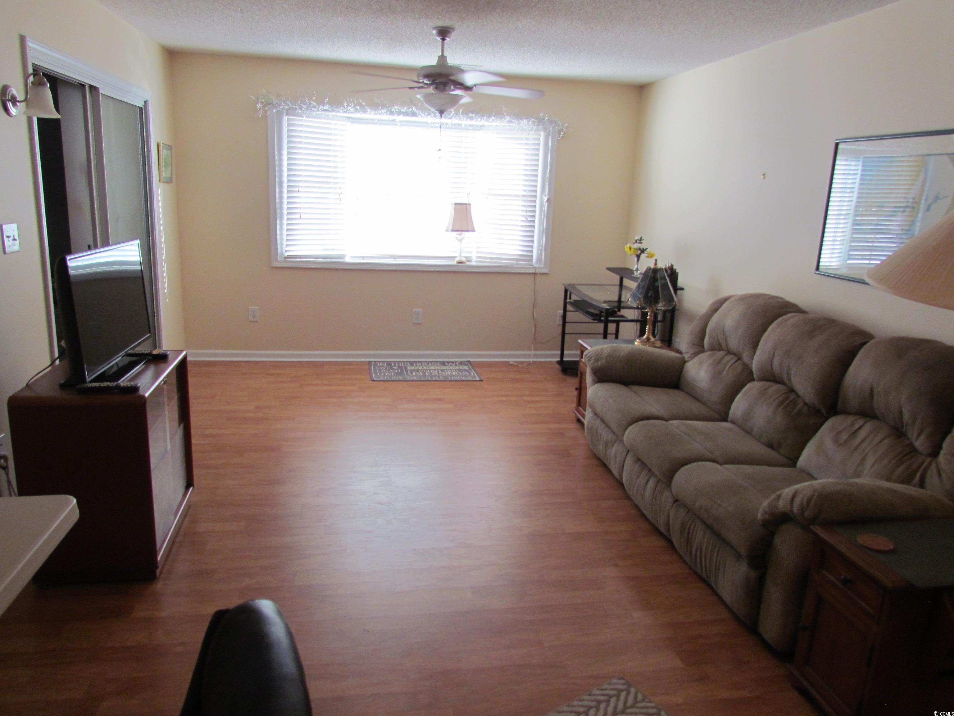 100 Inverness Court Myrtle Beach, SC 29588 - Photo 18 of 22 Living room featuring a textured ceiling, wood finished floors, and ceiling fan