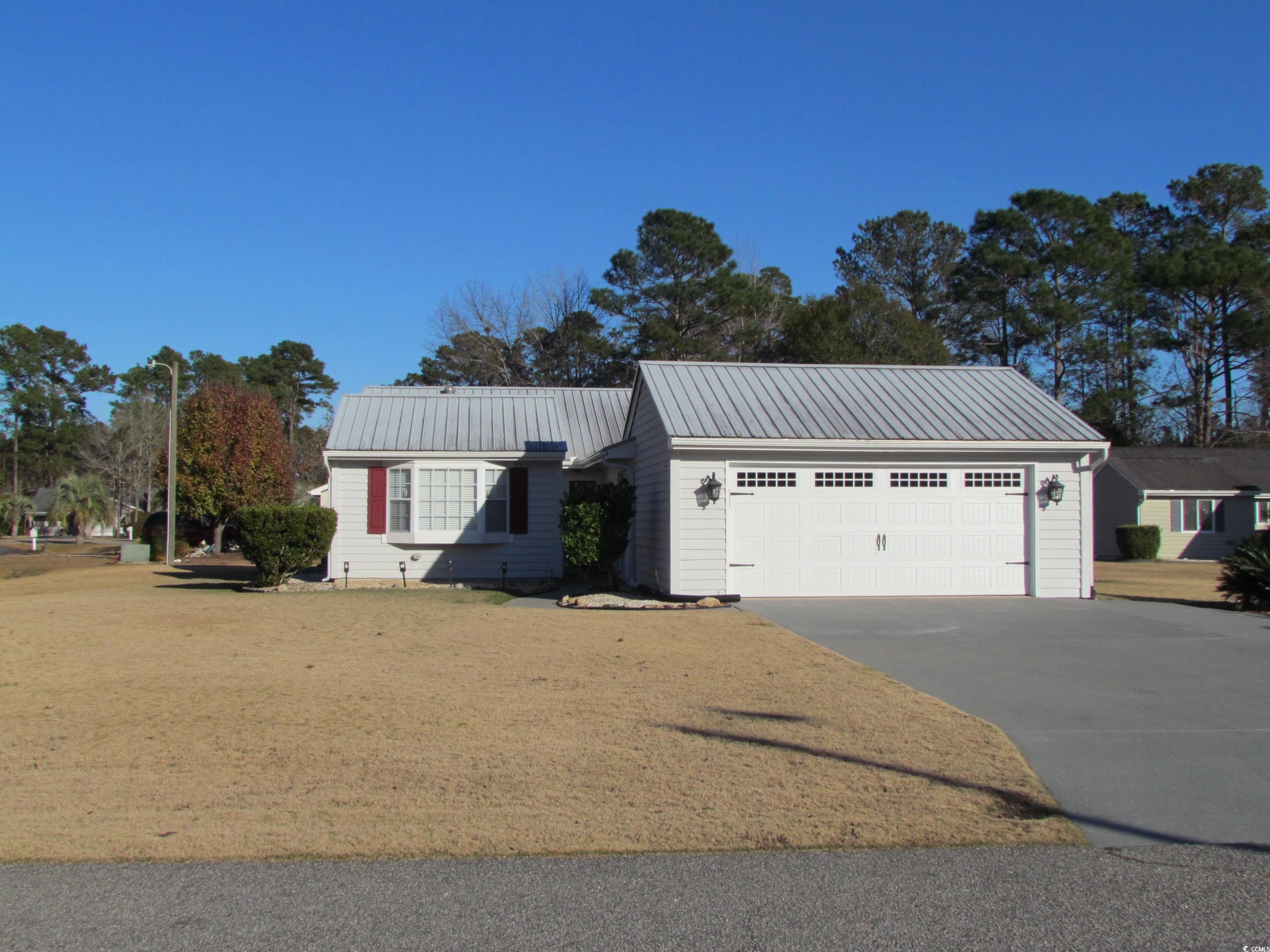 100 Inverness Court Myrtle Beach, SC 29588 - Photo 2 of 22 Garage featuring concrete driveway
