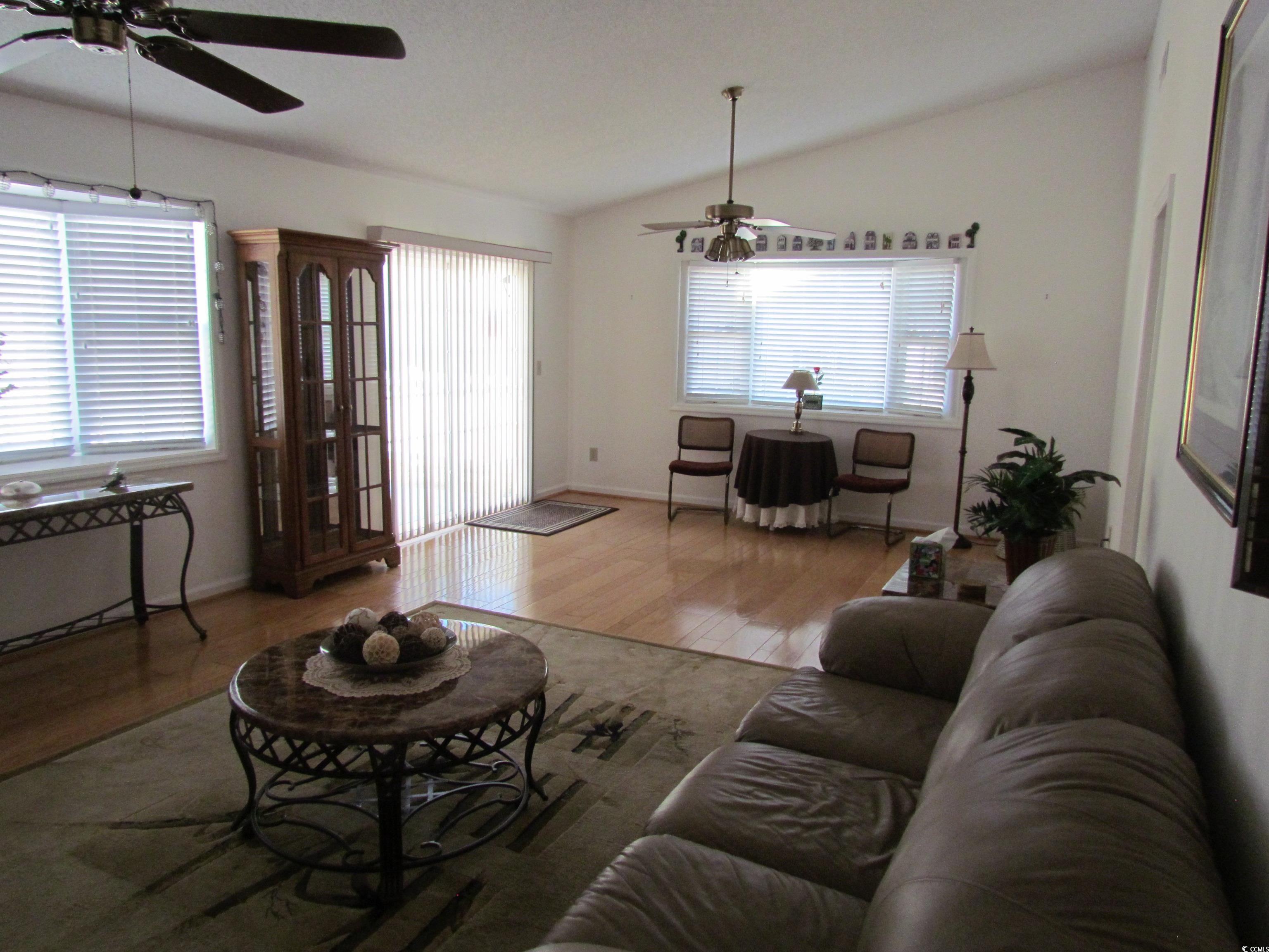 100 Inverness Court Myrtle Beach, SC 29588 - Photo 22 of 22 Living area with wood finished floors, a ceiling fan, and lofted ceiling