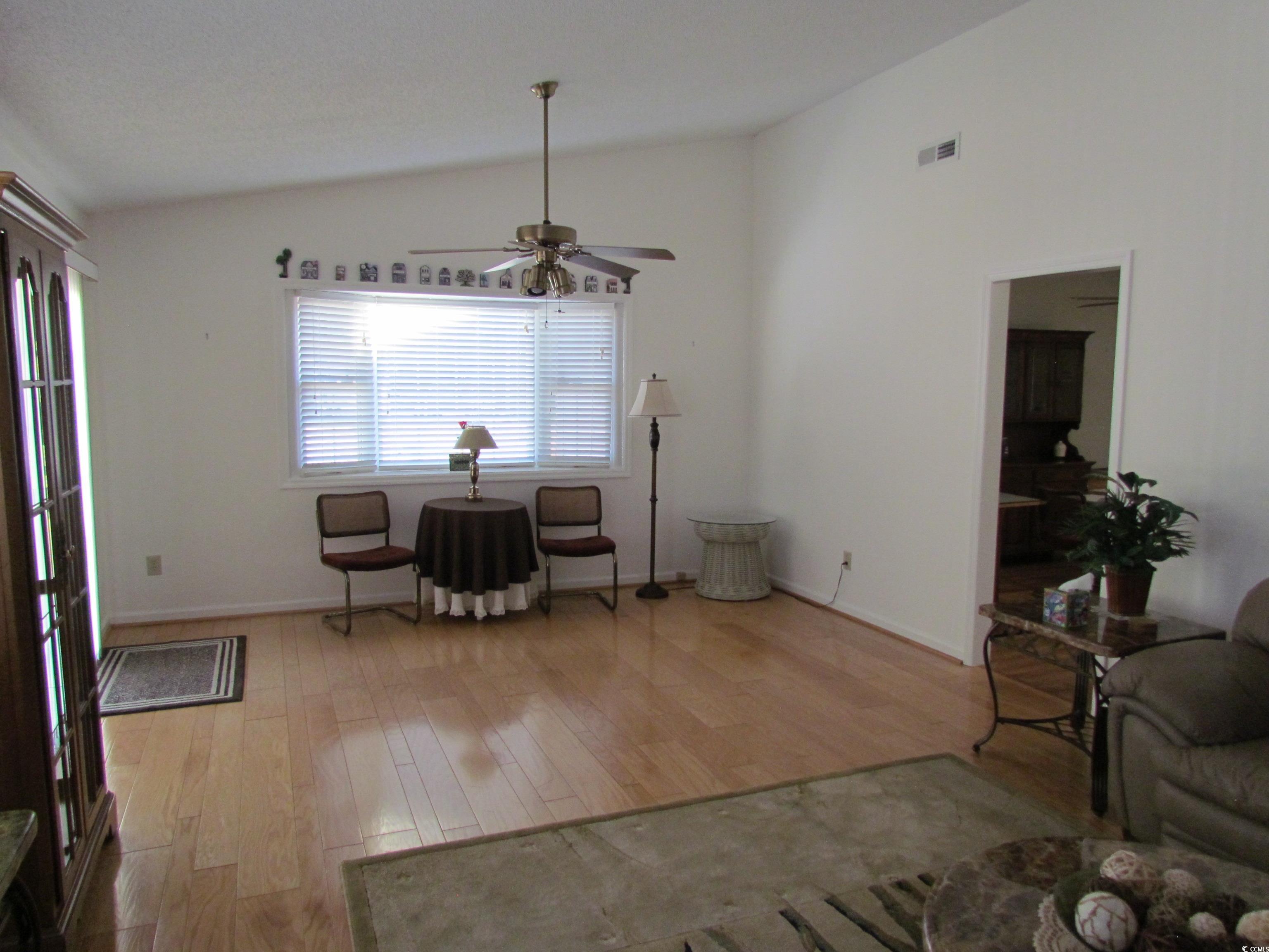 100 Inverness Court Myrtle Beach, SC 29588 - Photo 6 of 22 Sitting room featuring light wood-type flooring, lofted ceiling, and ceiling fan