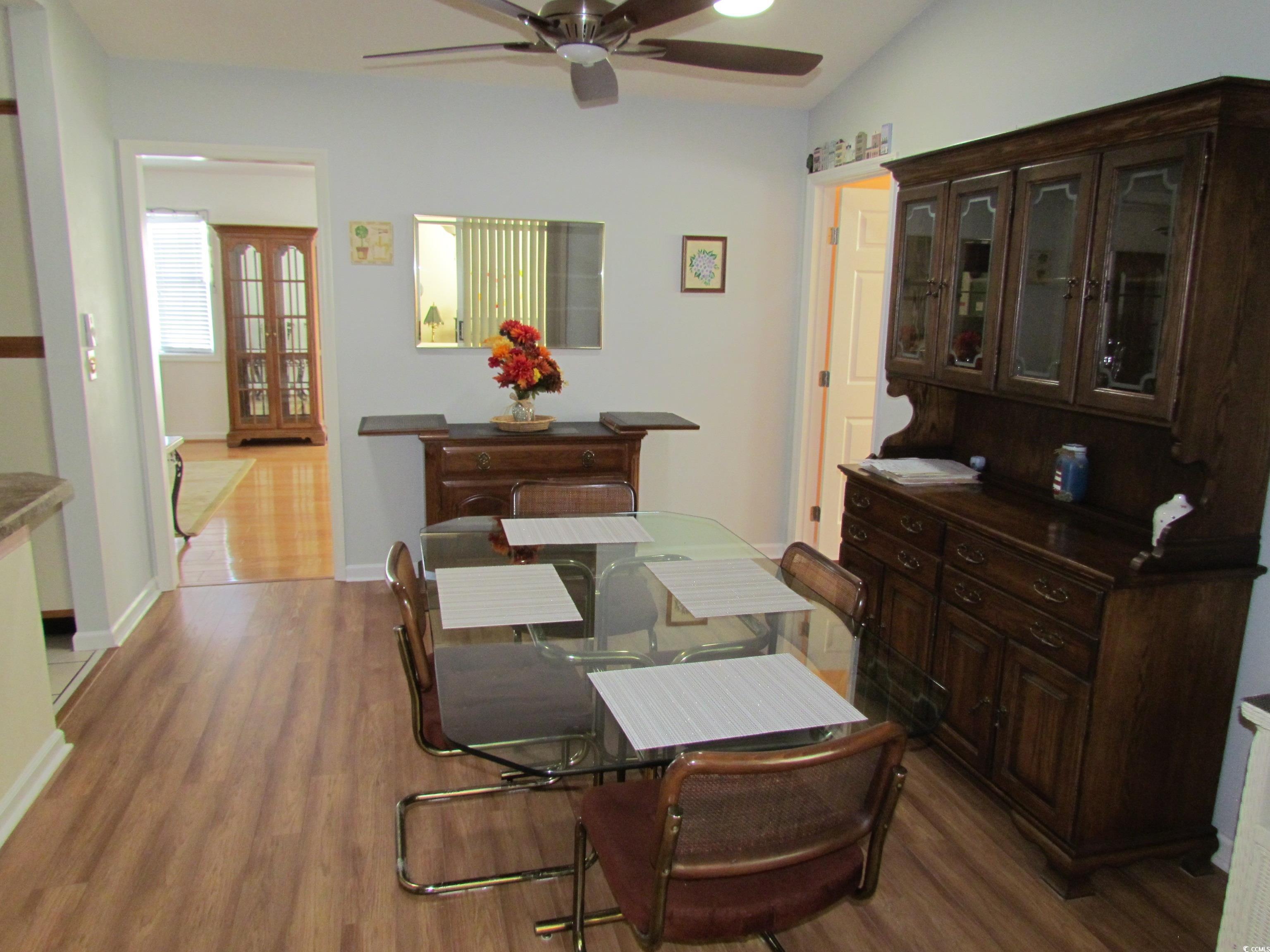 100 Inverness Court Myrtle Beach, SC 29588 - Photo 7 of 22 Dining room with dark wood-style floors, ceiling fan, and lofted ceiling