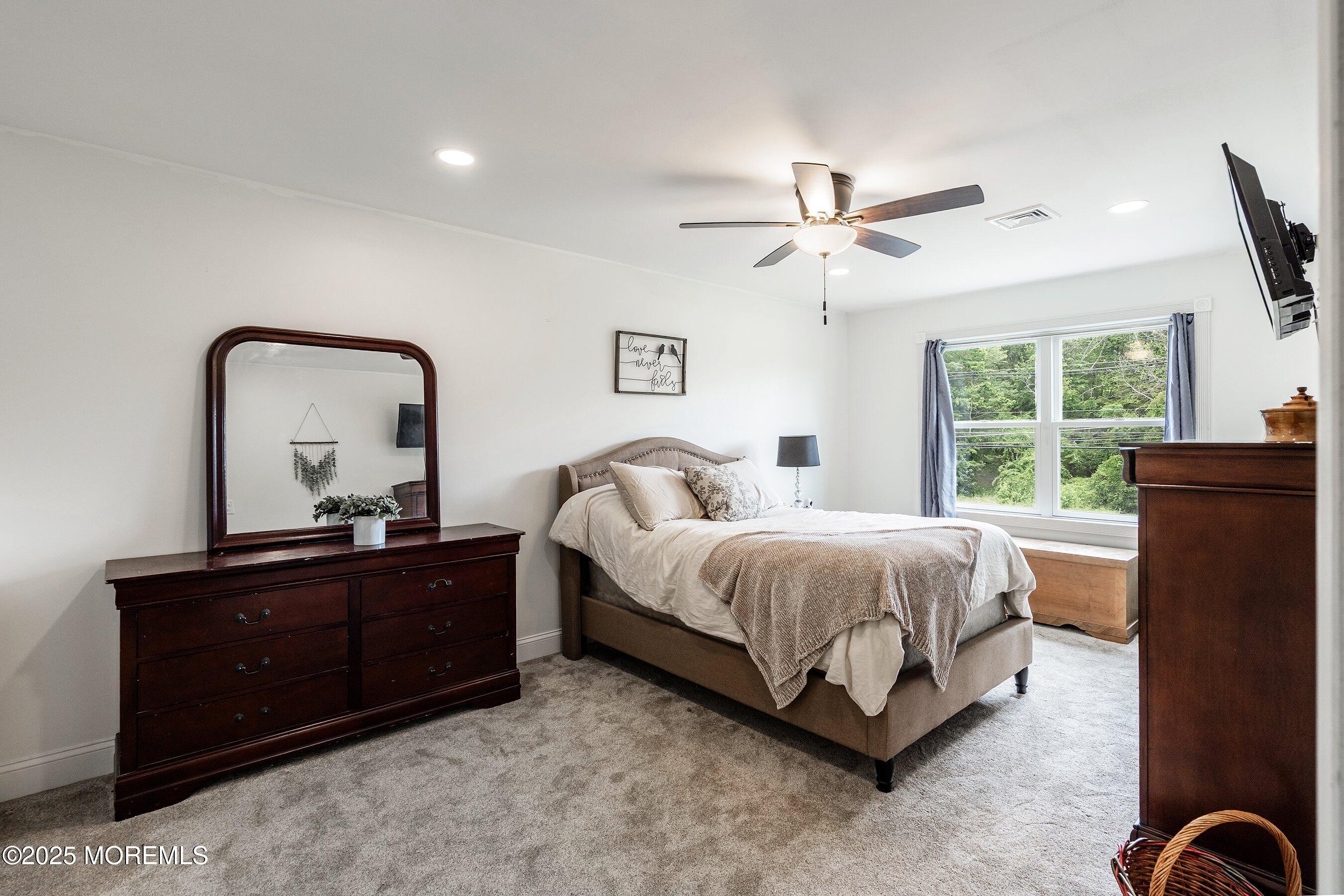 92 Jacobstown Road New Egypt, NJ 08533 - Photo 14 of 27 a bedroom with a bed and a dresser next to a window