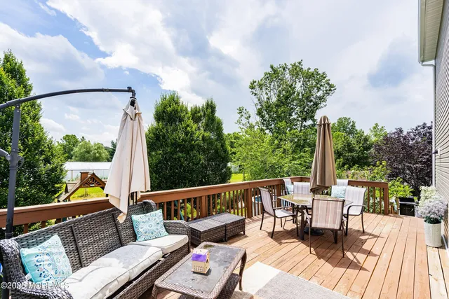 a view of balcony with wooden floor and outdoor seating