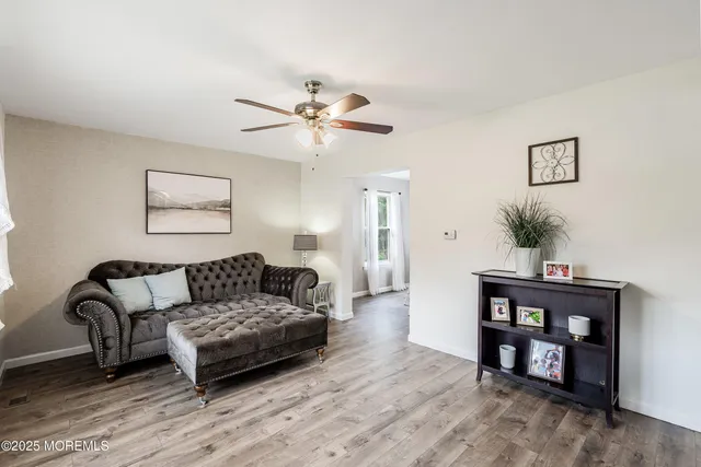 a living room with furniture and wooden floor