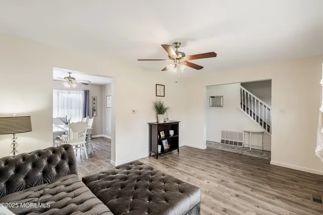 a living room with furniture and wooden floor