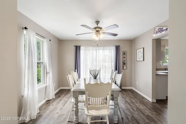 a view of a dining room with furniture window and wooden floor