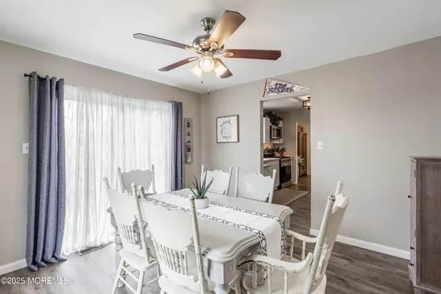 a view of a dining room with furniture and wooden floor