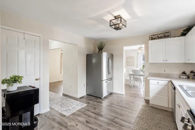 a kitchen with stainless steel appliances kitchen island granite countertop a refrigerator and a stove top oven