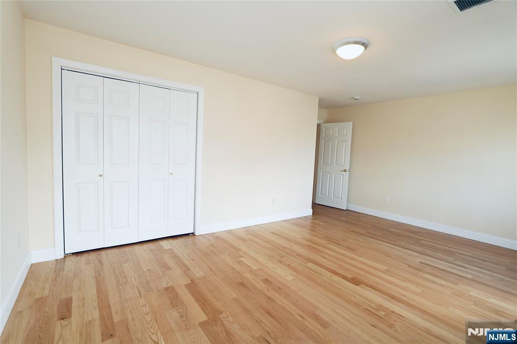 23 Main Avenue Wallington, NJ 07057 - Photo 28 of 29 a view of an empty room with wooden floor