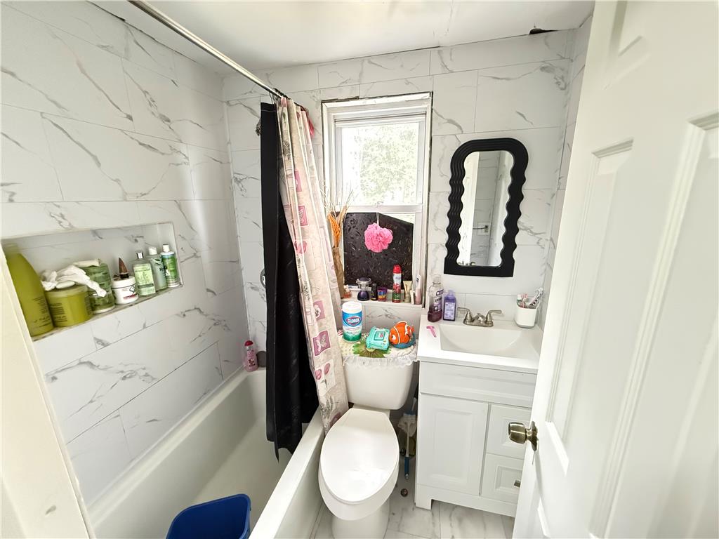 700 Philo Street Scranton, PA 18508 - Photo 12 of 19 A well-appointed bath with tiled walls and a functional shower-tub combination.
